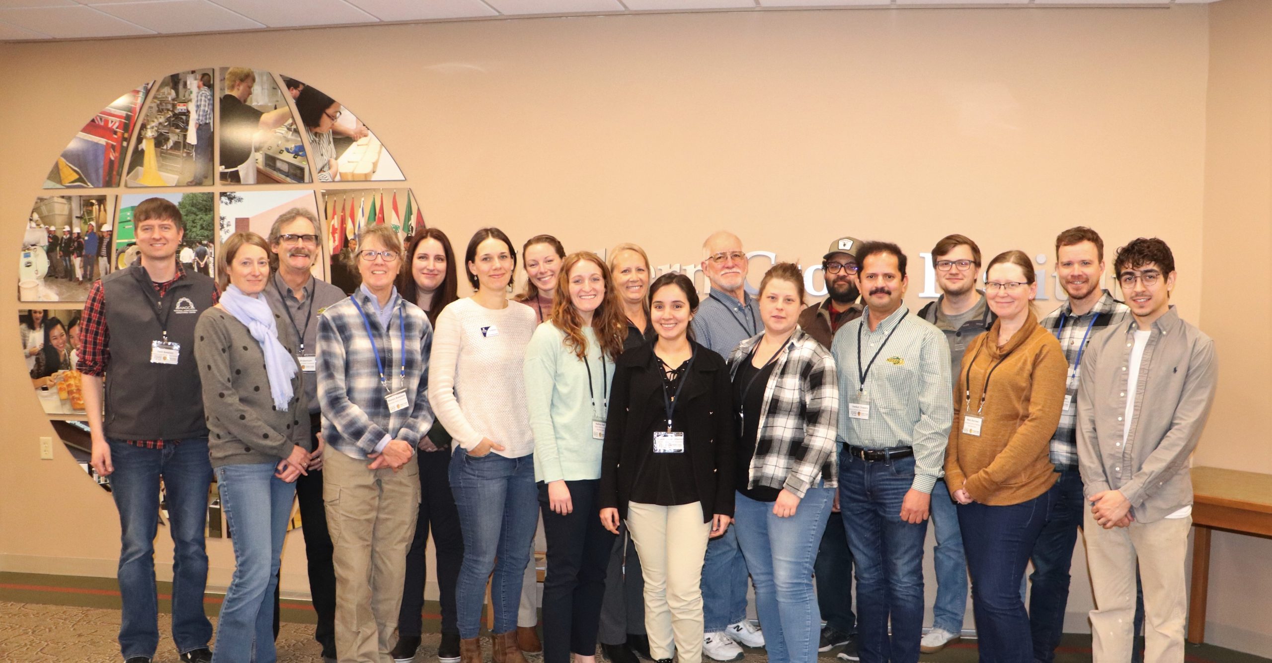 A group of 18 people posing for a group picture.